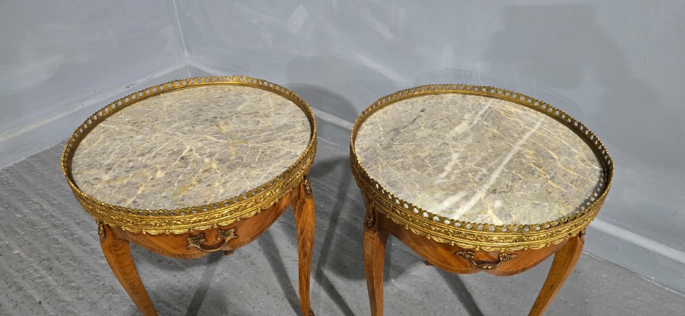 A pair of circular French kingwood side tables featuring grey marble tops, pierced brass galleries, and cabriole legs. View IV