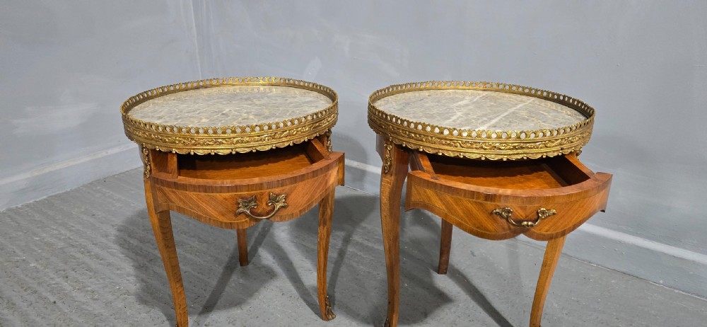 A pair of circular French kingwood side tables featuring grey marble tops, pierced brass galleries, and cabriole legs. View V
