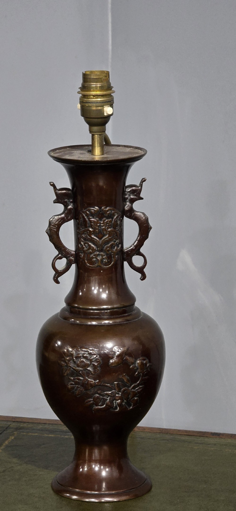A pair of dark patinated Japanese bronze vase table lamps with dragon handles and flared cream fabric shades. View IV