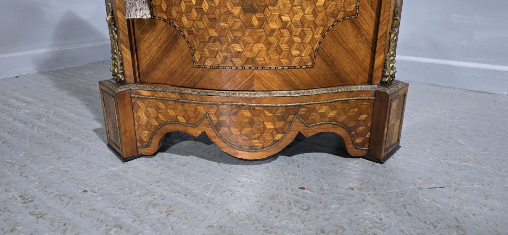 A French Louis XV style serpentine side cabinet featuring geometric cubework parquetry inlay, a single door, and decorative gilt-bronze mounts. View III
