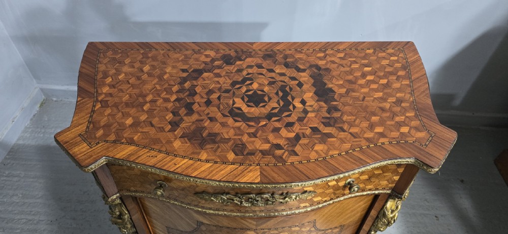 A French Louis XV style serpentine side cabinet featuring geometric cubework parquetry inlay, a single door, and decorative gilt-bronze mounts. View XI