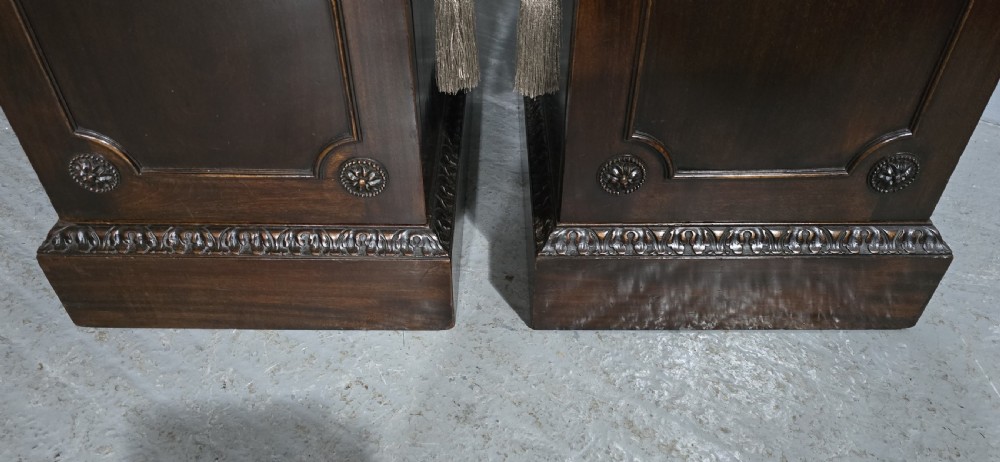 A pair of dark mahogany Regency style side cabinets featuring carved swags, floral rosettes, stepped tops, and plinth bases. View III