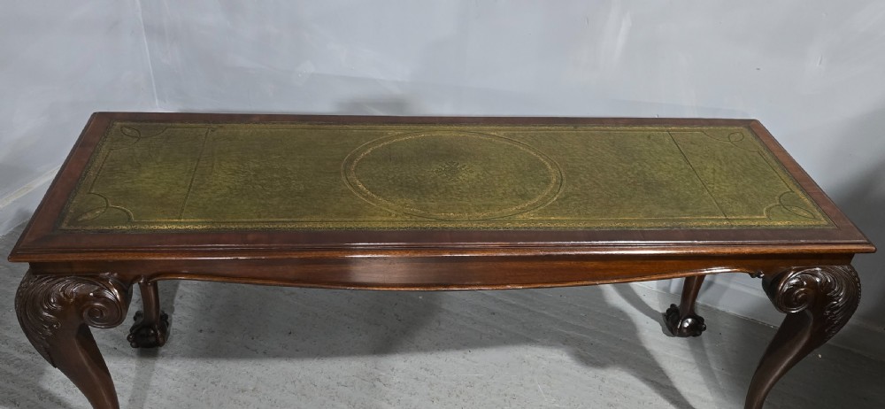 A mahogany console table featuring a green gold-tooled leather inset top and carved cabriole legs ending in ball-and-claw feet. View VI