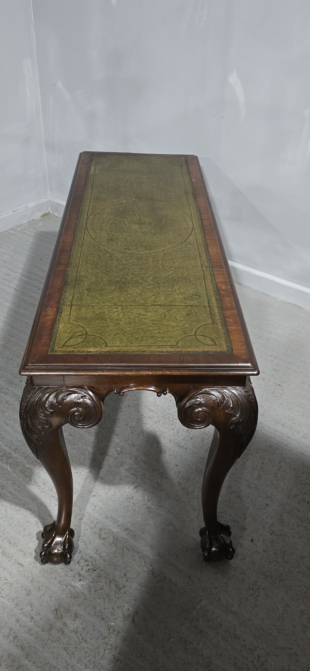 A mahogany console table featuring a green gold-tooled leather inset top and carved cabriole legs ending in ball-and-claw feet. View XI