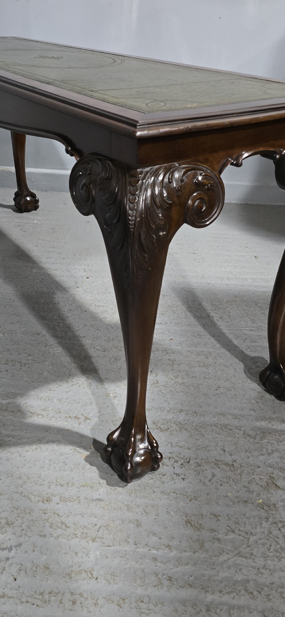 A mahogany console table featuring a green gold-tooled leather inset top and carved cabriole legs ending in ball-and-claw feet. View XIV
