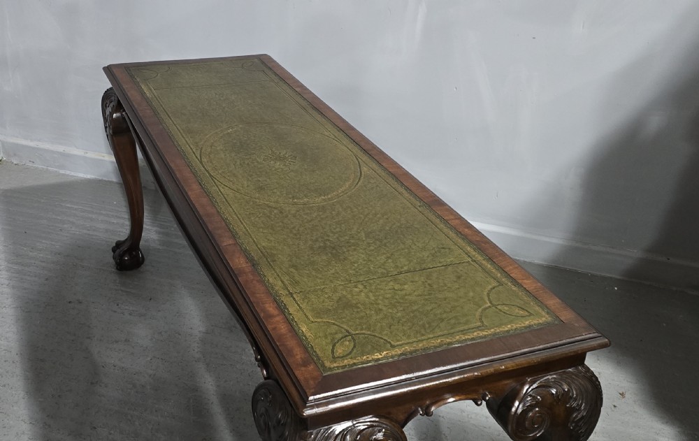 A mahogany console table featuring a green gold-tooled leather inset top and carved cabriole legs ending in ball-and-claw feet. View XV