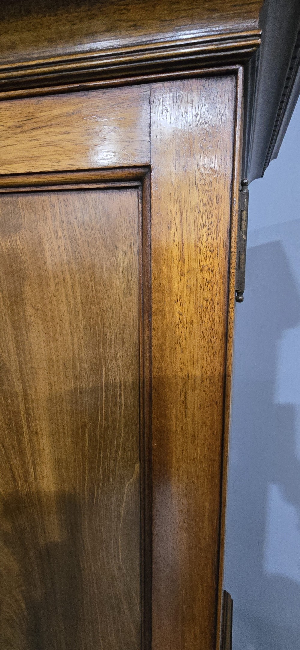 A tall mahogany linen press featuring a double-door upper cupboard with flame mahogany panels over four long drawers with turned knobs. View XIII