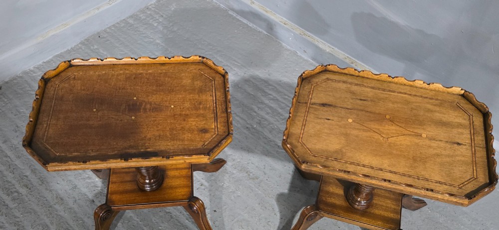 A pair of matching English walnut wine tables featuring gallery tops with wood inlay, turned central pedestals, and splayed legs. View X