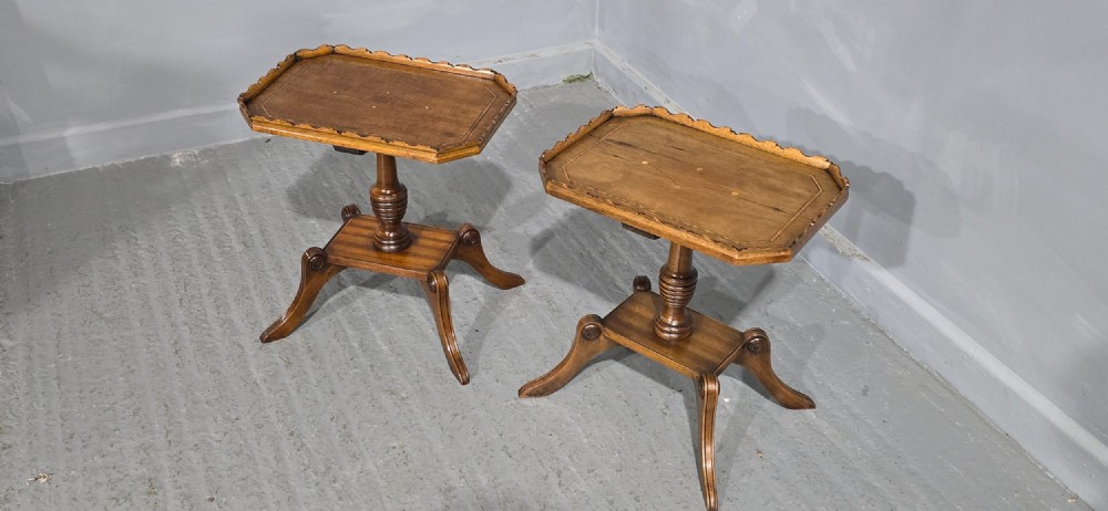 A pair of matching English walnut wine tables featuring gallery tops with wood inlay, turned central pedestals, and splayed legs. View XII