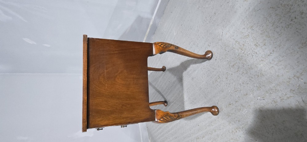 A Queen Anne style burr walnut lowboy table featuring cabriole legs with carved knees, pad feet, brass drop handles, and a shaped apron. View III