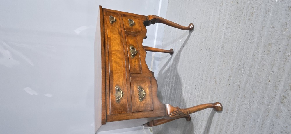 A Queen Anne style burr walnut lowboy table featuring cabriole legs with carved knees, pad feet, brass drop handles, and a shaped apron. View XIII