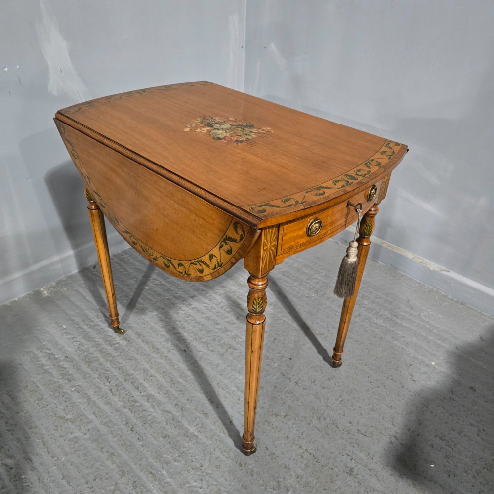 An antique painted satinwood Pembroke table featuring two drop leaves, hand-painted floral borders, turned tapering legs, and a single frieze drawer. View III