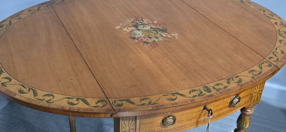 An antique painted satinwood Pembroke table featuring two drop leaves, hand-painted floral borders, turned tapering legs, and a single frieze drawer. View XI