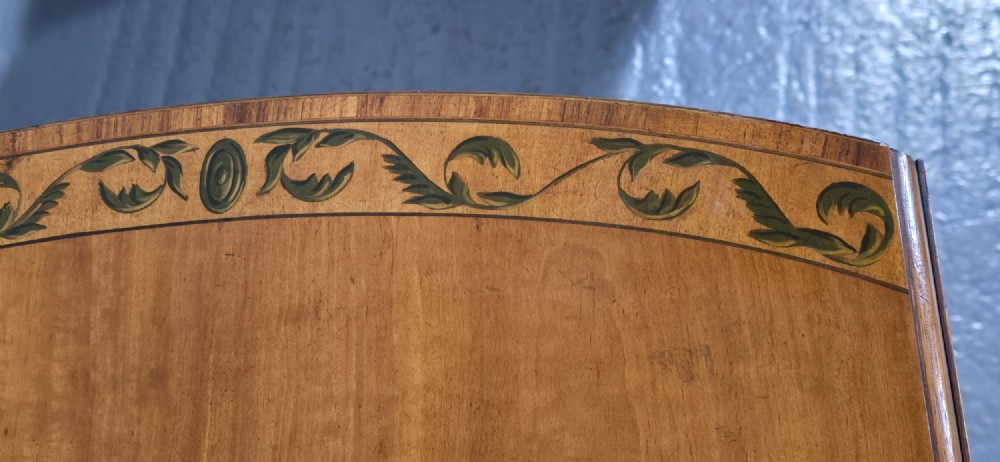 An antique painted satinwood Pembroke table featuring two drop leaves, hand-painted floral borders, turned tapering legs, and a single frieze drawer. View XIII
