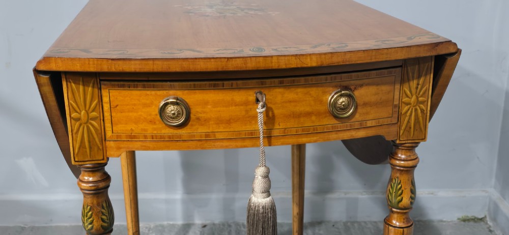 An antique painted satinwood Pembroke table featuring two drop leaves, hand-painted floral borders, turned tapering legs, and a single frieze drawer. View XV