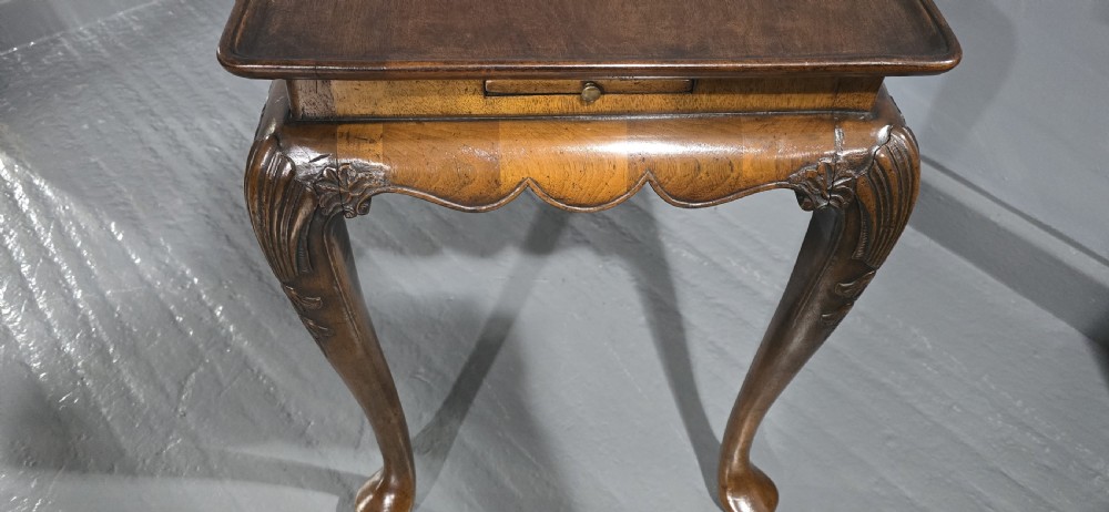 A rectangular walnut tray-top table with a moulded lip rim, a scalloped frieze, and carved cabriole legs. View VIII