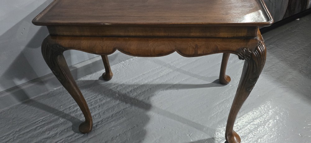 A rectangular walnut tray-top table with a moulded lip rim, a scalloped frieze, and carved cabriole legs. View IX