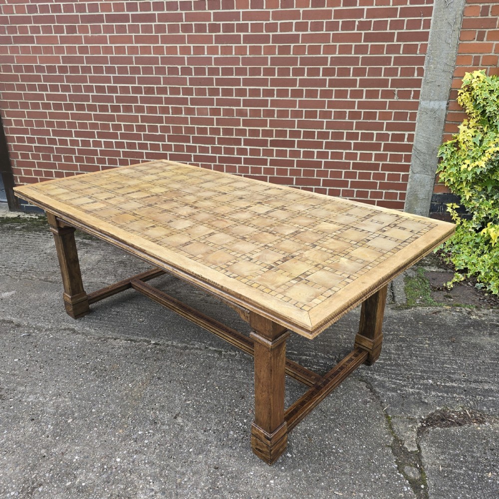 A large rectangular French refectory dining table featuring a patterned parquet timber top, square block legs, and a low stretcher base. View II