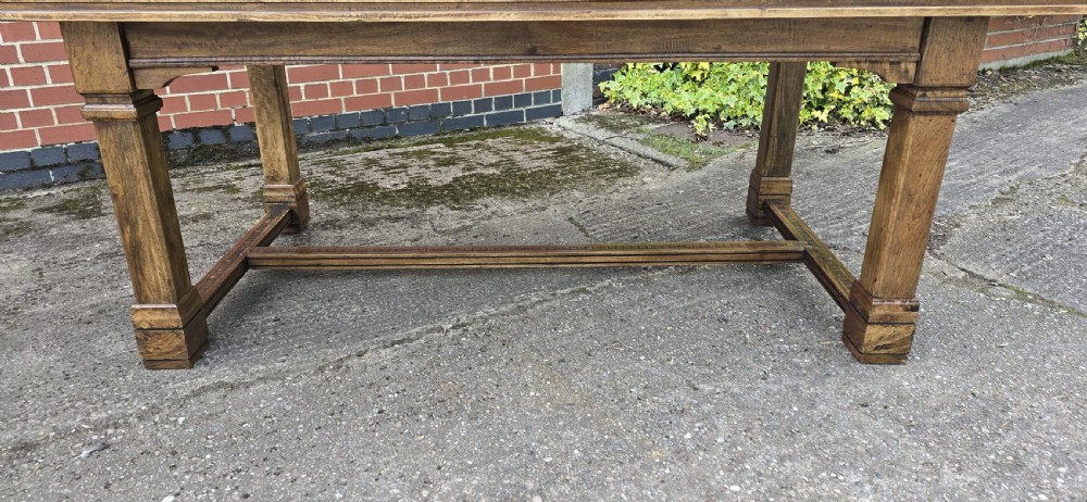 A large rectangular French refectory dining table featuring a patterned parquet timber top, square block legs, and a low stretcher base. View IV