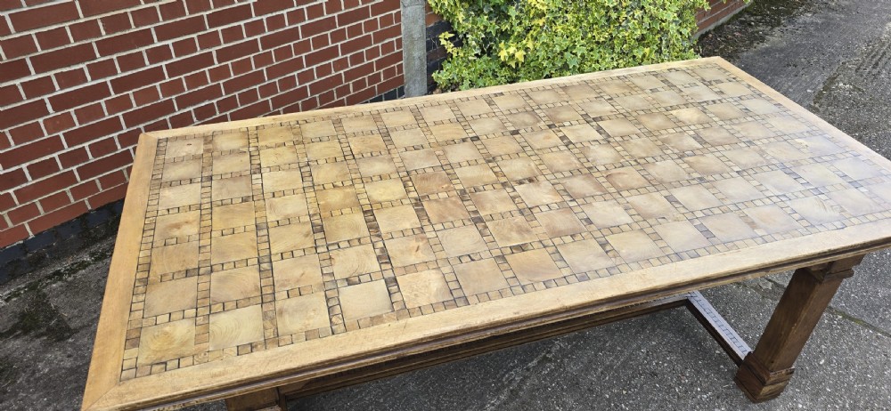 A large rectangular French refectory dining table featuring a patterned parquet timber top, square block legs, and a low stretcher base. View VIII