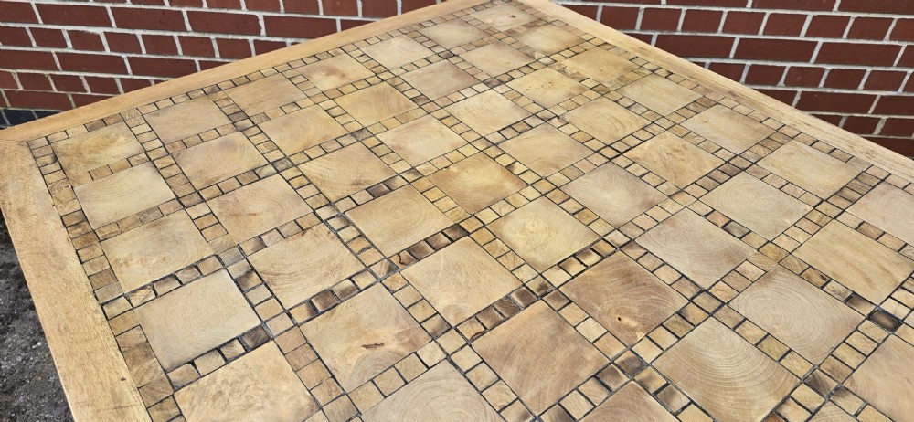 A large rectangular French refectory dining table featuring a patterned parquet timber top, square block legs, and a low stretcher base. View XII