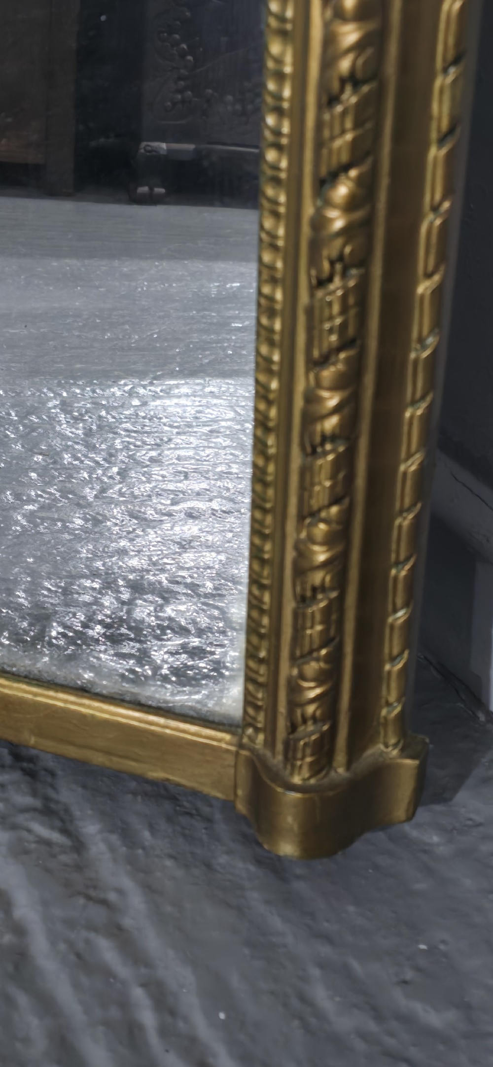 A Victorian arched overmantel mirror with an ornate gilded frame featuring detailed beaded moulding and a flat base. View VI
