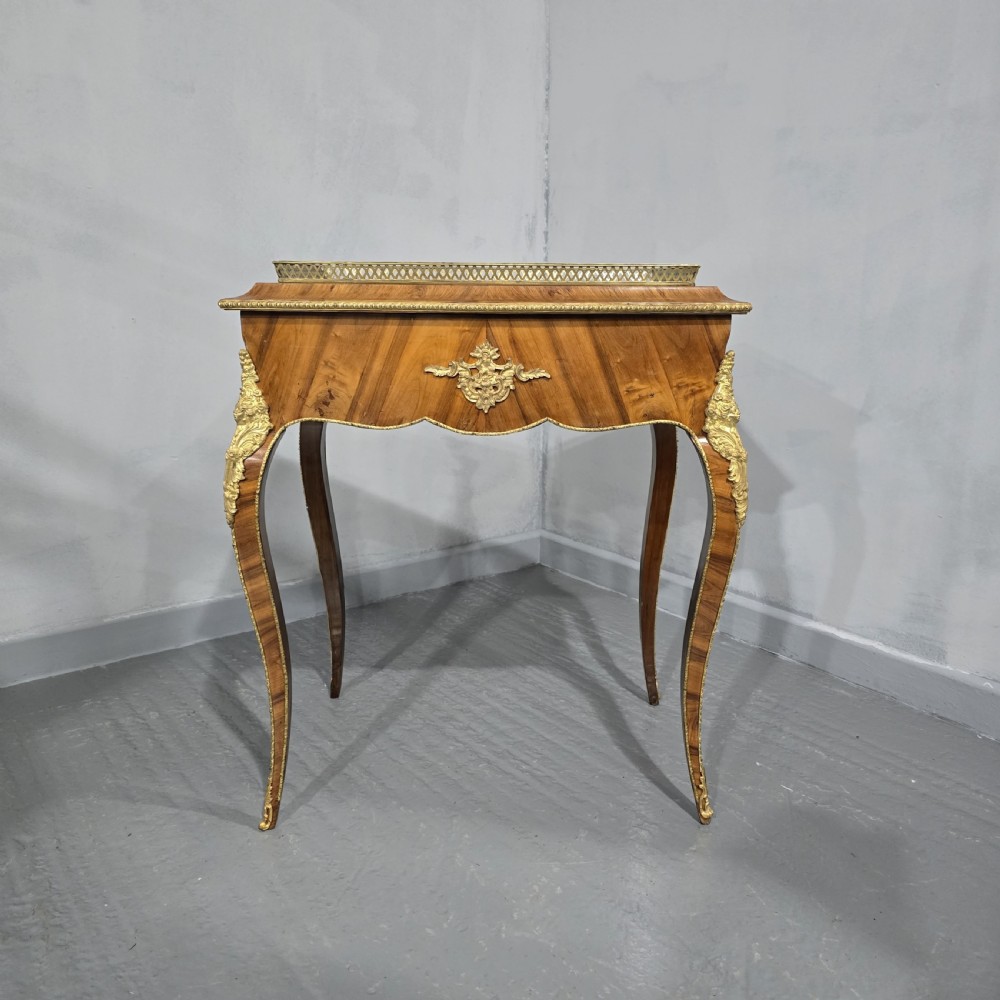 A Louis XV style satinwood jardiniere table featuring quartered wood veneer, ornate gilded bronze mounts, cabriole legs, a pierced brass gallery, and a metal liner. View III