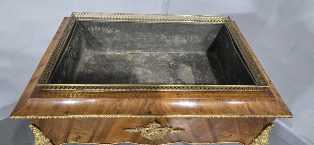 A Louis XV style satinwood jardiniere table featuring quartered wood veneer, ornate gilded bronze mounts, cabriole legs, a pierced brass gallery, and a metal liner. View VII