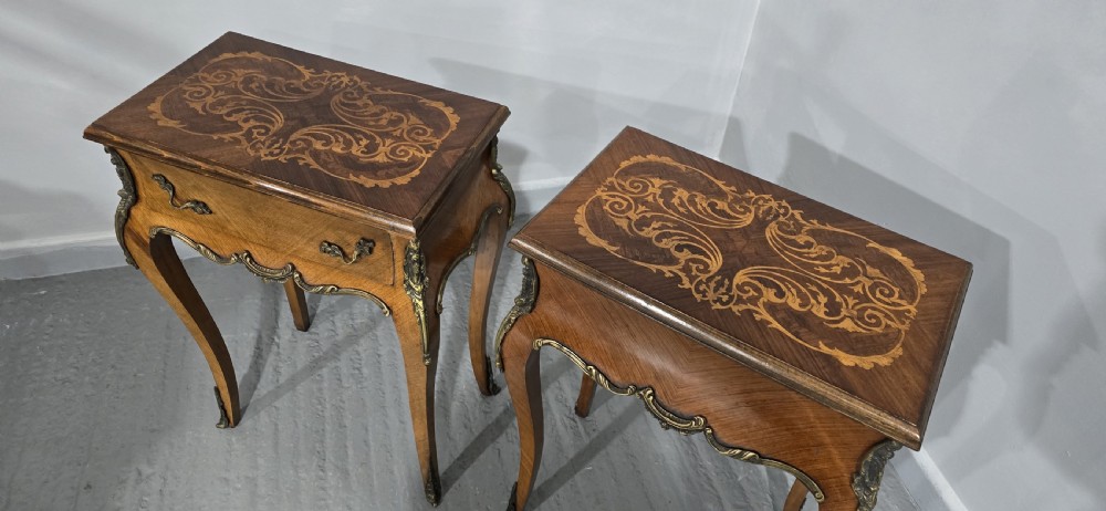 A pair of French Rococo style bedside tables with marquetry tops, single drawers, and ornate brass mounts on cabriole legs. View XI