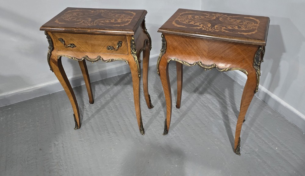 A pair of French Rococo style bedside tables with marquetry tops, single drawers, and ornate brass mounts on cabriole legs. View XII