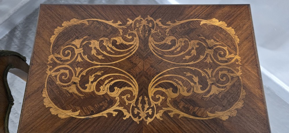 A pair of French Rococo style bedside tables with marquetry tops, single drawers, and ornate brass mounts on cabriole legs. View XIII
