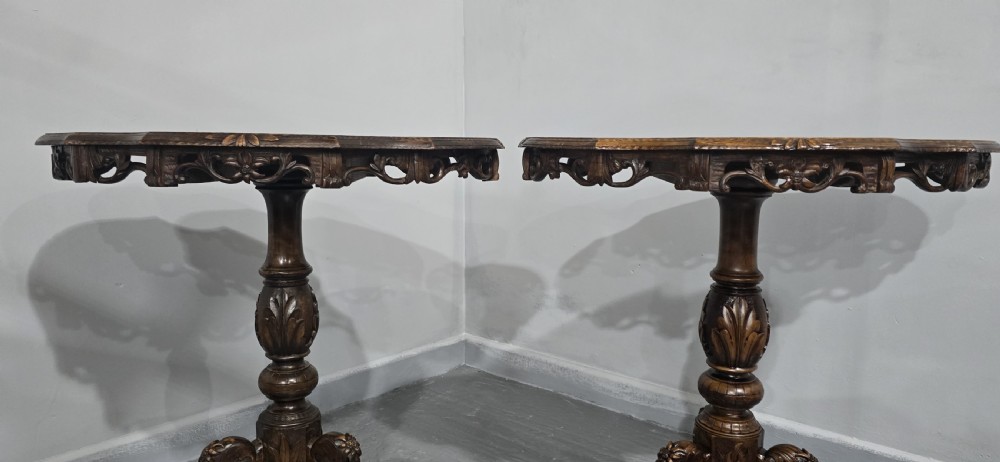 A pair of antique Black Forest carved walnut side tables featuring intricate marquetry tops with animal silhouettes on tripod pedestal bases. View VIII