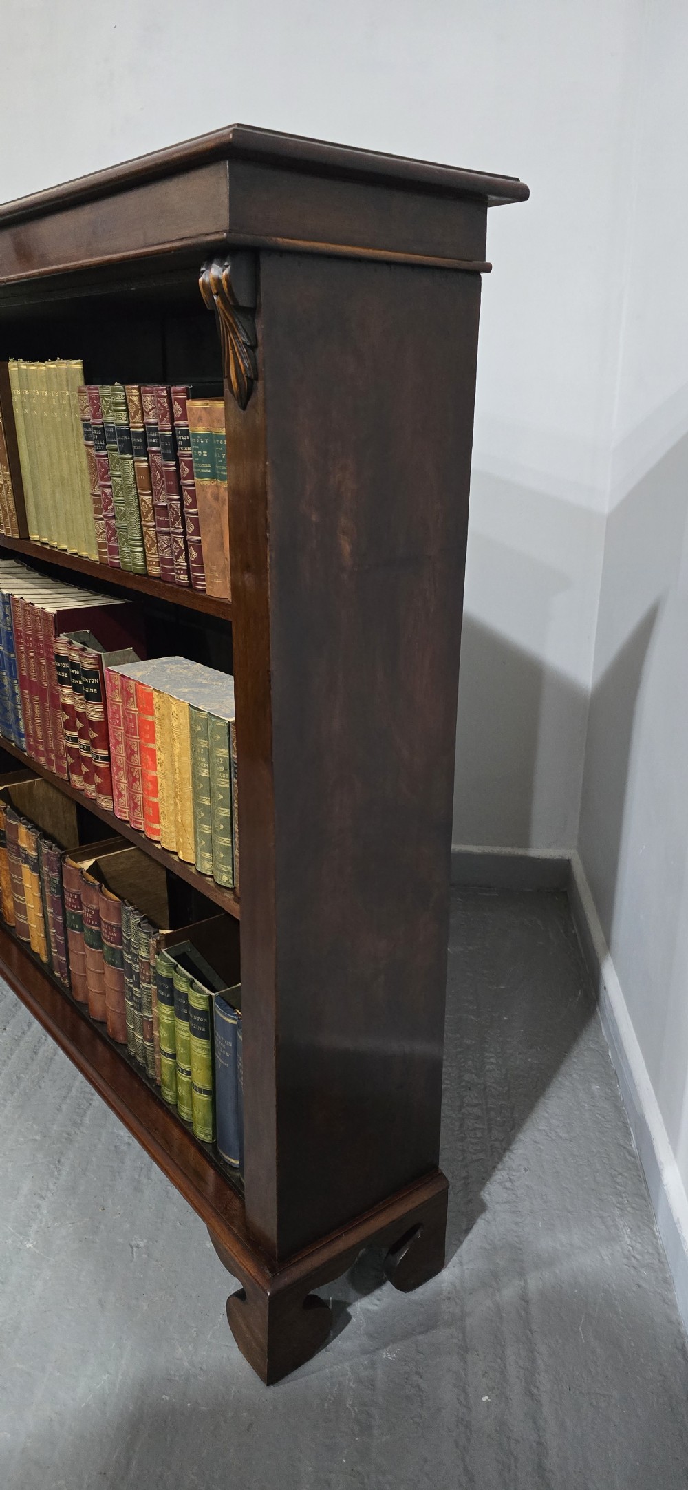 A Victorian mahogany open bookcase featuring three adjustable shelves filled with leather-bound books, flanked by carved corbels. View III