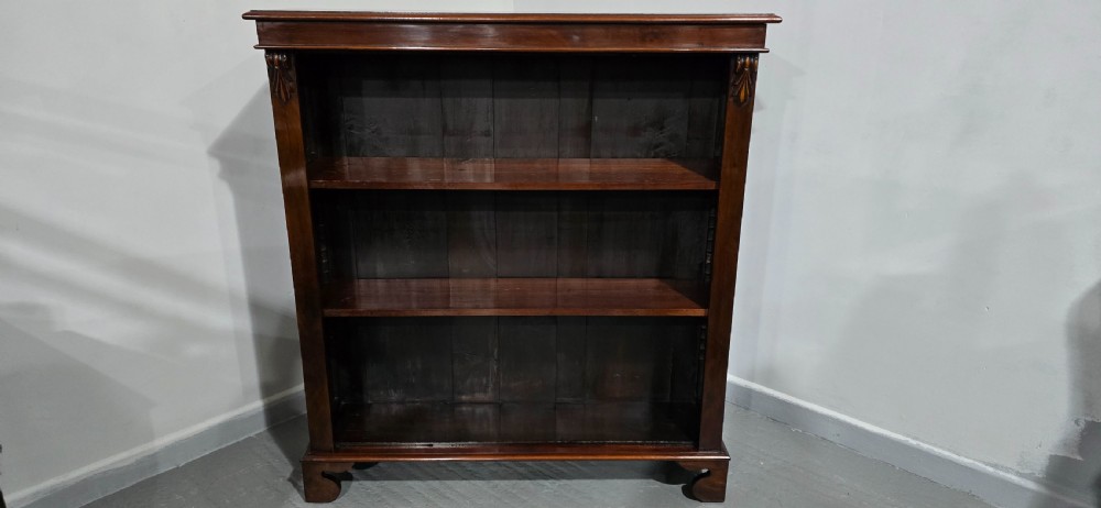 A Victorian mahogany open bookcase featuring three adjustable shelves filled with leather-bound books, flanked by carved corbels. View VIII