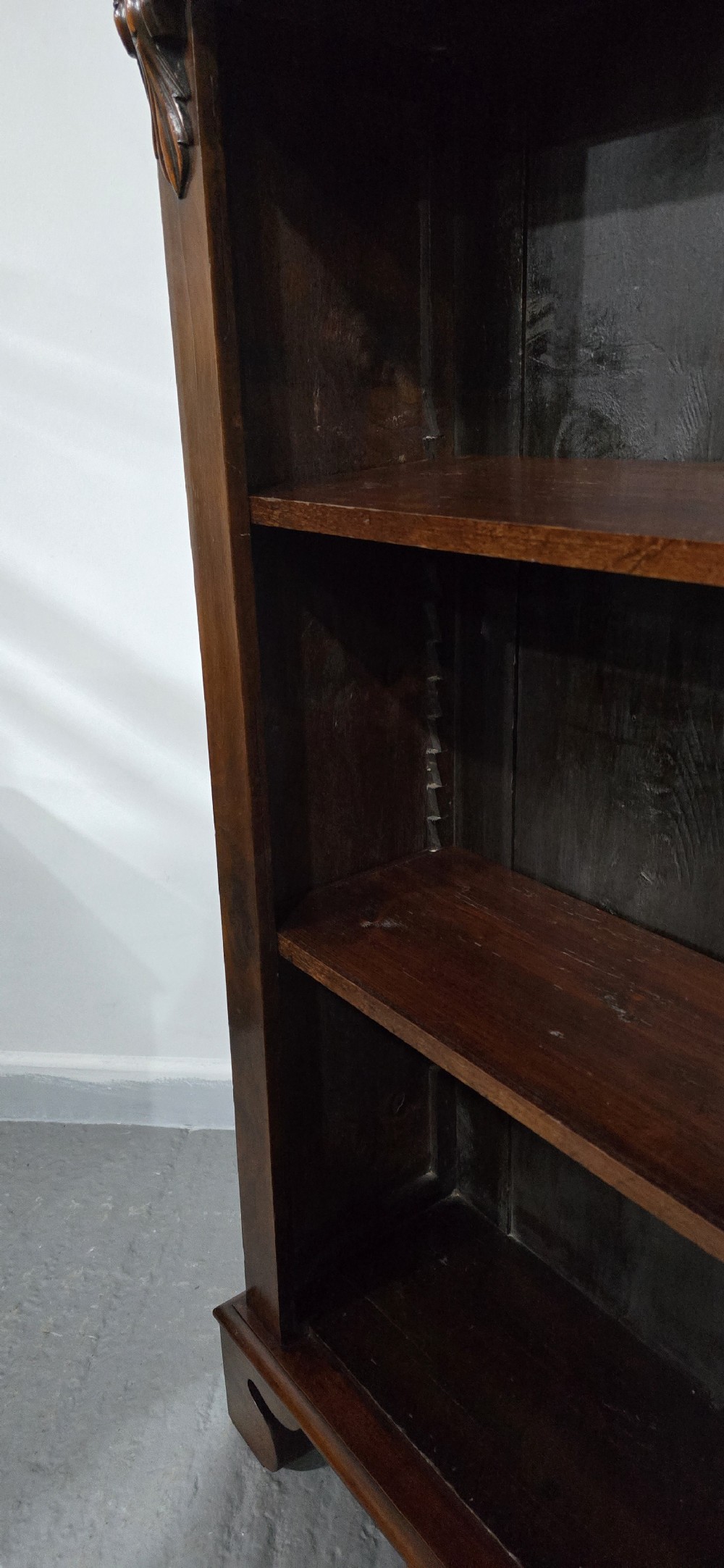 A Victorian mahogany open bookcase featuring three adjustable shelves filled with leather-bound books, flanked by carved corbels. View IX