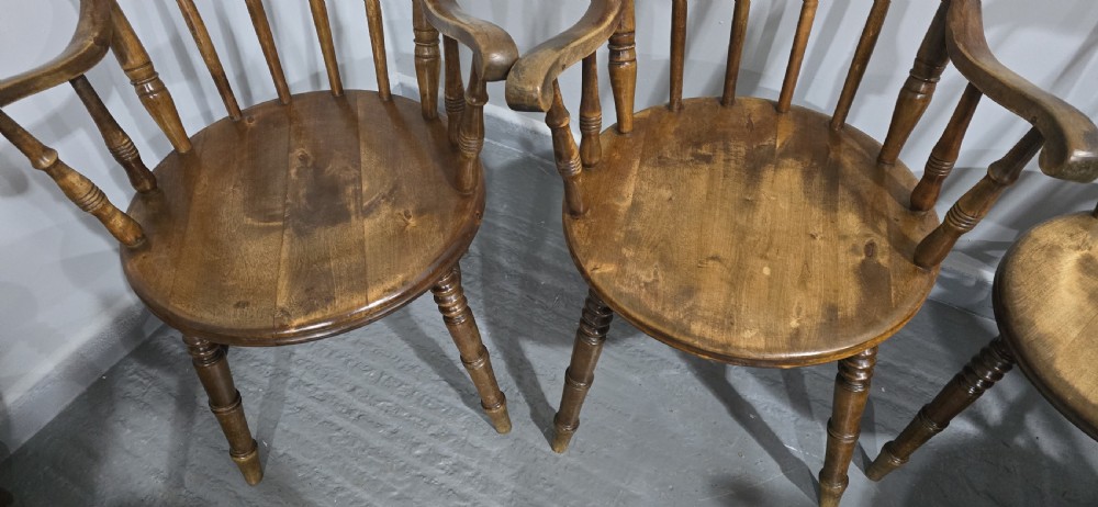 A set of eight antique warm brown wooden kitchen chairs with spindle backrests, turned legs, and contoured seats, including two armchairs. View VIII