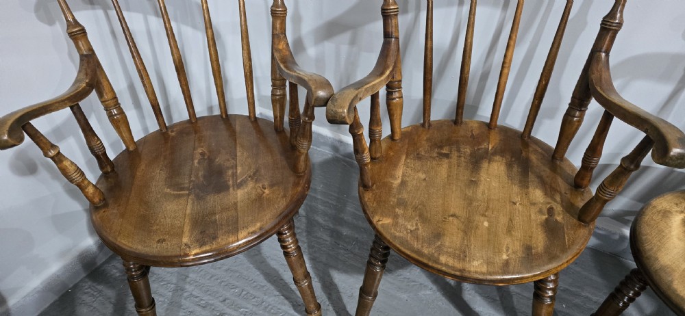 A set of eight antique warm brown wooden kitchen chairs with spindle backrests, turned legs, and contoured seats, including two armchairs. View IX
