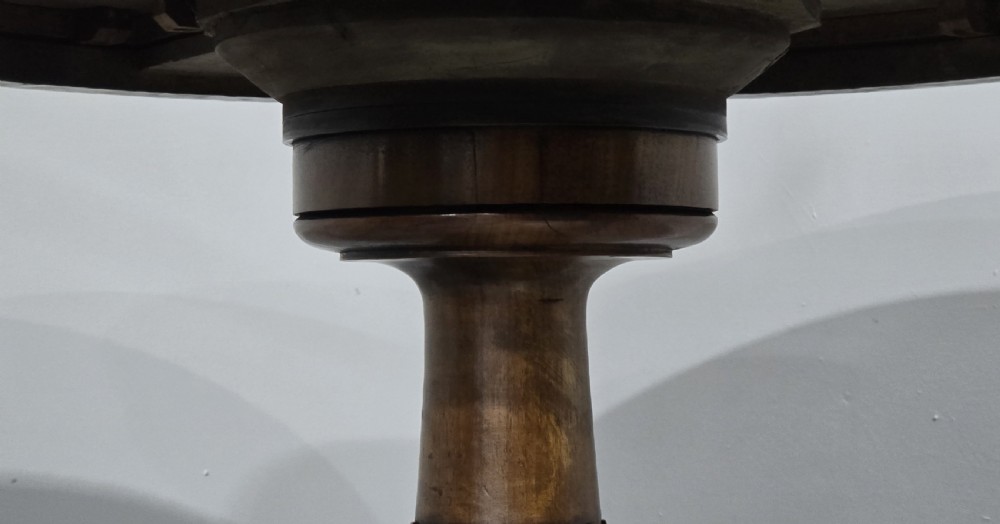 A circular Victorian walnut library table featuring a reddish-brown leather inset top, turned central pedestal stem, and carved tripod legs with scroll feet. View VI