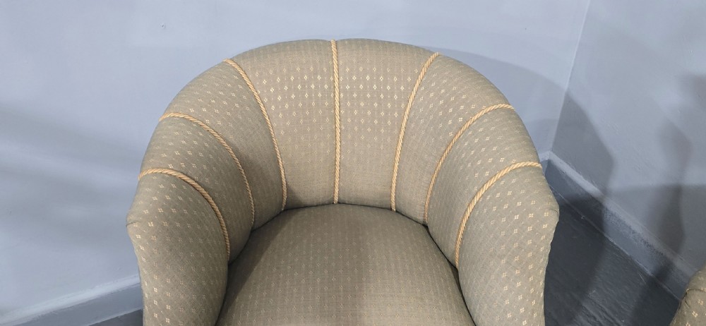 A pair of French walnut tub chairs upholstered in light beige patterned fabric with channelled backrests and turned wooden legs. View VII