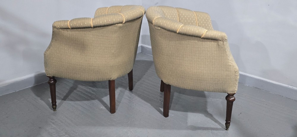 A pair of French walnut tub chairs upholstered in light beige patterned fabric with channelled backrests and turned wooden legs. View XI