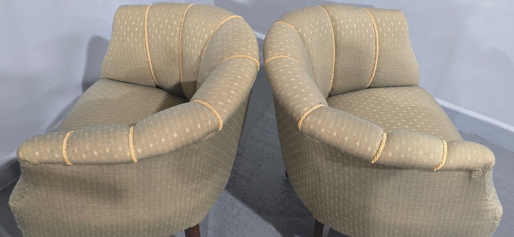 A pair of French walnut tub chairs upholstered in light beige patterned fabric with channelled backrests and turned wooden legs. View XII