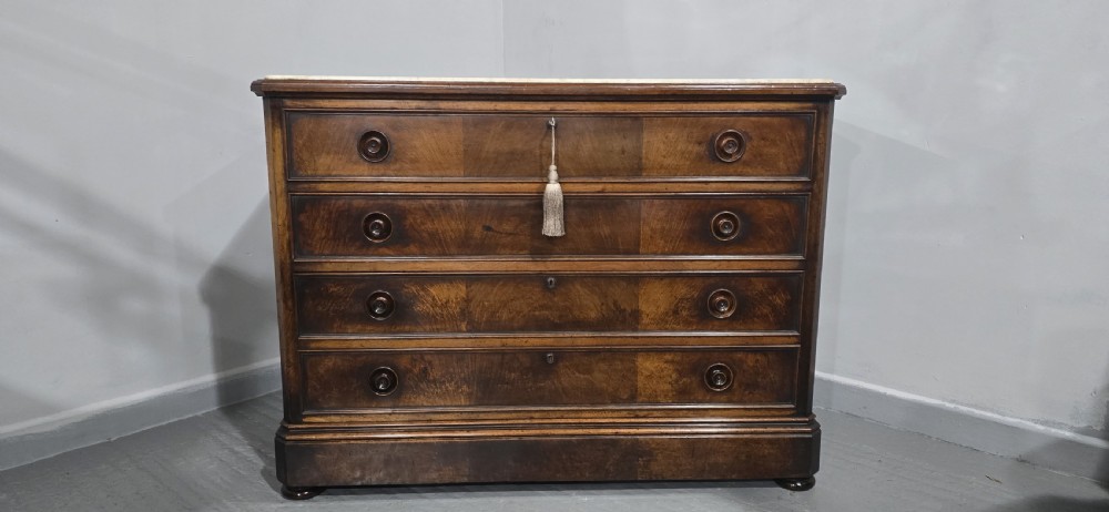 A nineteenth-century French walnut commode with four drawers, turned knobs, and a flat top. View III