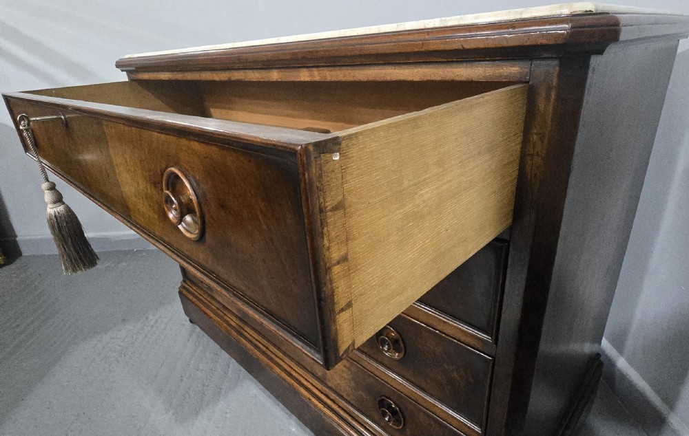 A nineteenth-century French walnut commode with four drawers, turned knobs, and a flat top. View VIII