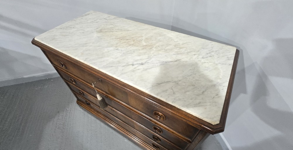 A nineteenth-century French walnut commode with four drawers, turned knobs, and a flat top. View XIII