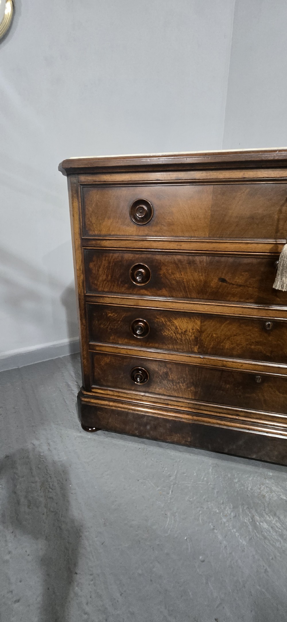 A nineteenth-century French walnut commode with four drawers, turned knobs, and a flat top. View XVI