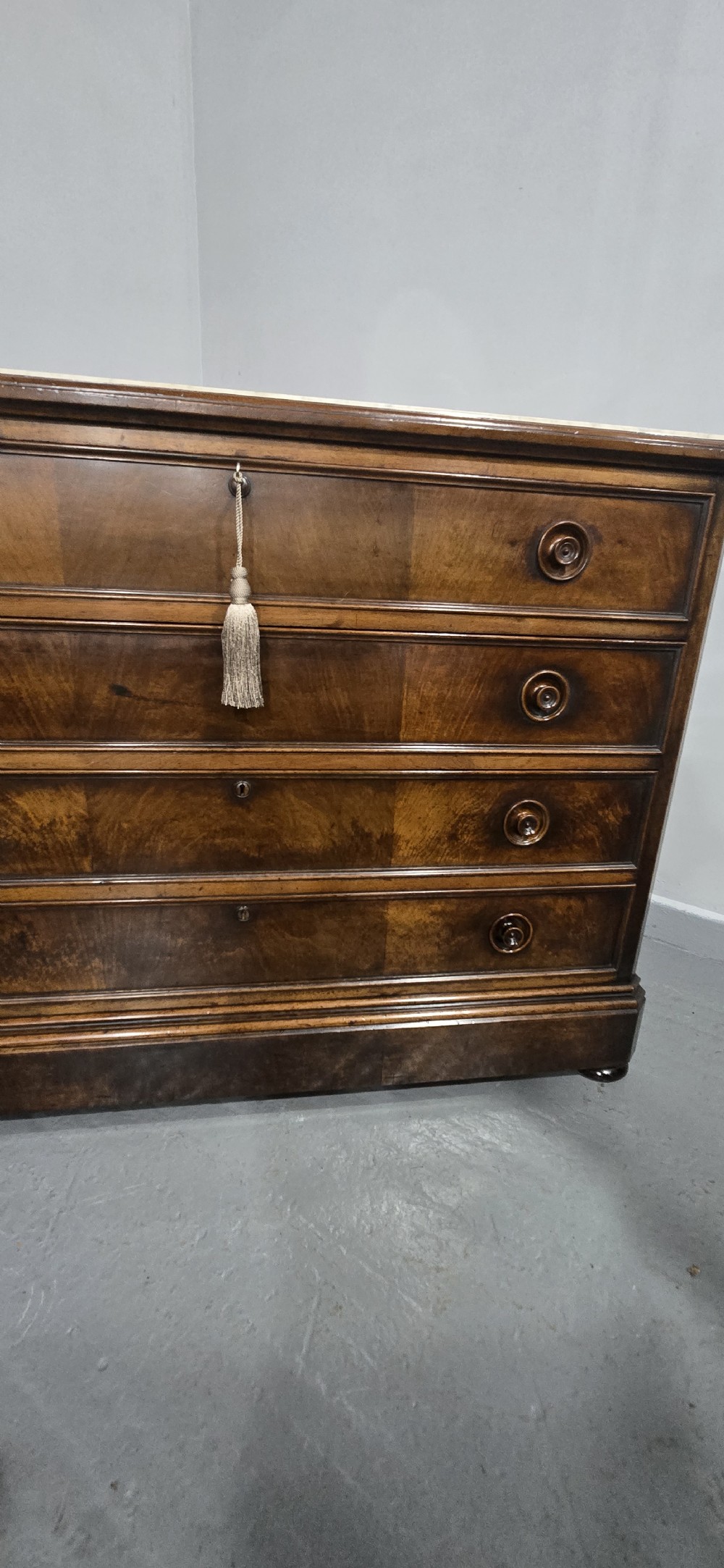 A nineteenth-century French walnut commode with four drawers, turned knobs, and a flat top. View XVII