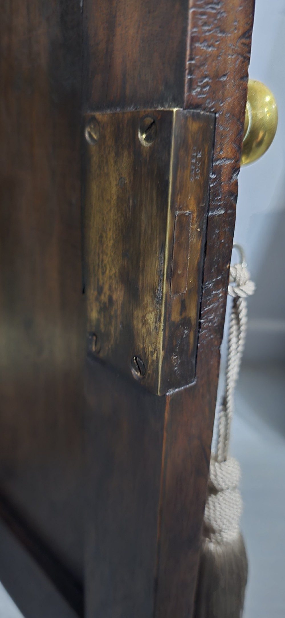 A dark oak Georgian breakfront dresser base featuring brass swan-neck handles, three central drawers, and two outer cupboard doors set on bracket feet. View XII