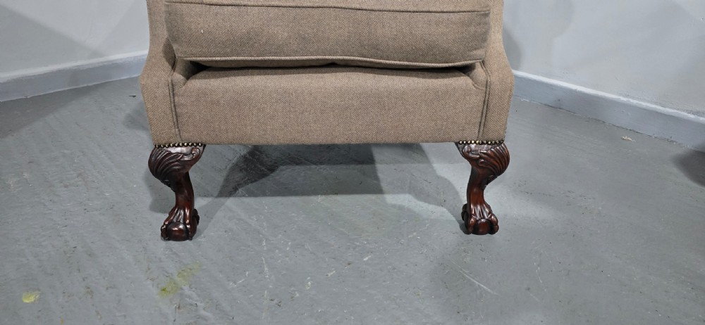 A traditional upholstered armchair in neutral taupe wool featuring carved mahogany cabriole front legs and claw-and-ball feet. View IV