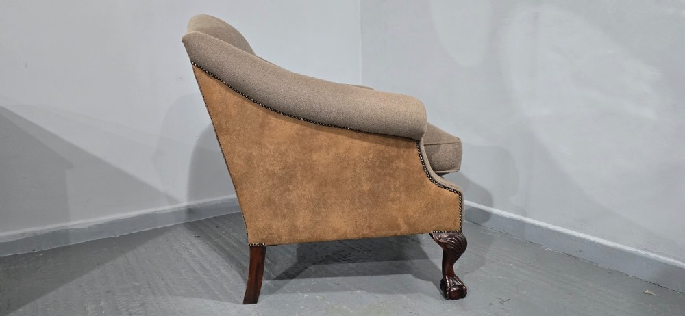 A traditional upholstered armchair in neutral taupe wool featuring carved mahogany cabriole front legs and claw-and-ball feet. View X