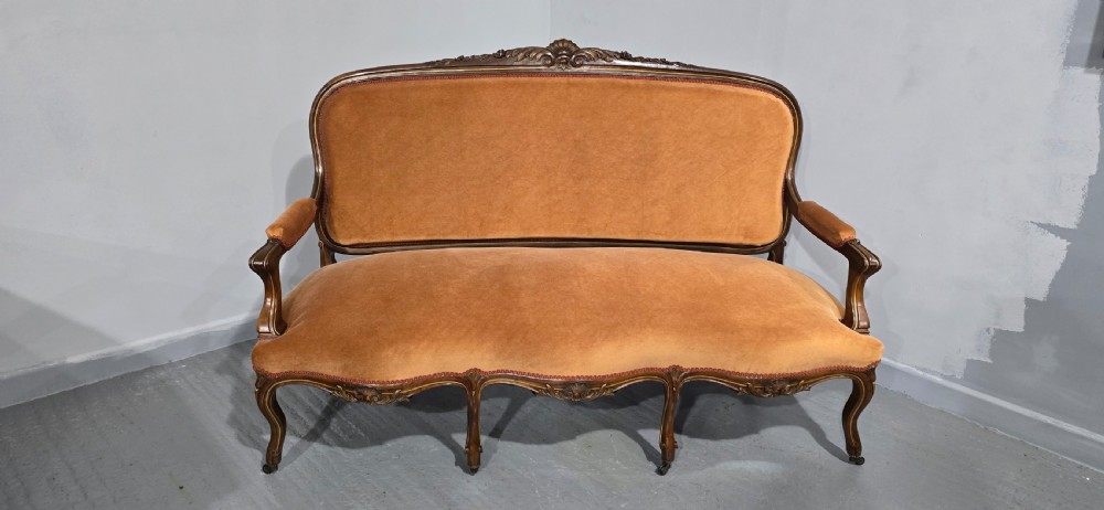 A French Louis XV style carved walnut settee with warm amber velvet upholstery, serpentine seat rail, and cabriole legs. View III